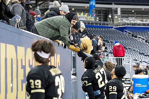 Daniel Crump / Winnipeg Free Press. Bisons players interact with fans after defeating the Alberta Golden Bears in the Canada West football semifinal at IG Field in Winnipeg on Saturday. November 13, 2021.