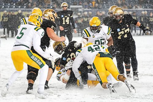Daniel Crump / Winnipeg Free Press. Bisons running back Noah Anderson (28) is tackled by several Golden Bears. University of Manitoba Bisons vs. University of Alberta Golden Bears during the Canada West football semifinal at IG Field in Winnipeg on Saturday. November 13, 2021.
