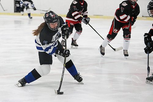 Daniel Crump / Winnipeg Free Press. A College Jeanne-Suave player [77 not on game sheet] shoots the puck. Winnipeg Women&#x573; High School Hockey League hockey Jeanne-Suave Olympiens vs. Beliveau Barracudas at the Southdale Arena in Winnipeg. November 17, 2021.