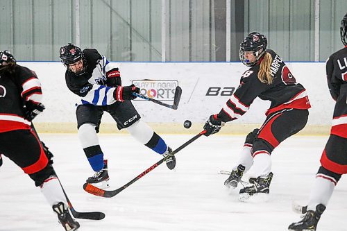 Daniel Crump / Winnipeg Free Press. College Jeanne-Suave&#x573; Annika Devine (12) shoots the puck during the first period. Winnipeg Women&#x573; High School Hockey League hockey Jeanne-Suave Olympiens vs. Beliveau Barracudas at the Southdale Arena in Winnipeg. November 17, 2021.