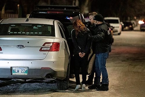 Daniel Crump / Winnipeg Free Press. Winnipeg police put a handcuffed person in the back of a police car following a standoff at an apartment block at 363 Mountain avenue. November 17, 2021.