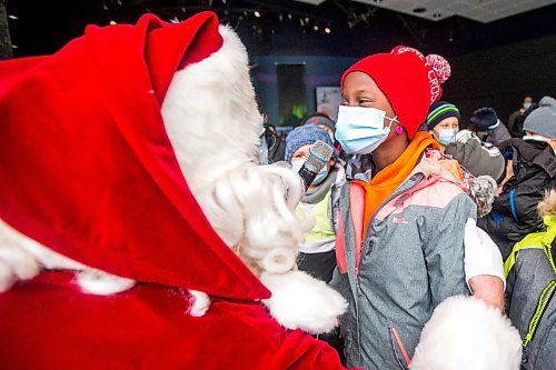 MIKAELA MACKENZIE / WINNIPEG FREE PRESS

Dara Orimolade, grade three student, tells Santa what she wants for Christmas as he visits kids from Lavallee School at a Winter Wonderland party organized by Variety at the Assiniboine Park Zoo in Winnipeg on Monday, Nov. 22, 2021. For Doug Speirs story.
Winnipeg Free Press 2021.