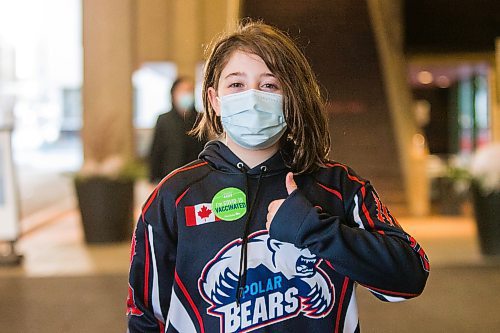 MIKAELA MACKENZIE / WINNIPEG FREE PRESS

Elodie Robert (ten) poses for a portrait in front of the RBC Convention Centre vaccination supersite after getting vaccinated in Winnipeg on Wednesday, Nov. 24, 2021. For --- story.
Winnipeg Free Press 2021.