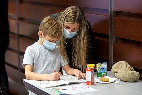 MIKE DEAL / WINNIPEG FREE PRESS
Grayson Walstra, 6, waits with his mother, Olivia Billson, for his turn to get his COVID-19 vaccination at the RBC Convention Centre Supersite, Thursday afternoon.
Manitoba is beginning to immunize children ages five to 11 against COVID-19 this week and thousands of parents have already booked appointments to protect their younger children during the fourth wave of the pandemic and into the holiday season, Health and Seniors Care Minister Audrey Gordon announced today. 
To help mark the launch of the vaccine campaign, six Manitoba children, joined by their family members for support, received their first dose of the pediatric Pfizer vaccine at the RBC Convention Centre super site in Winnipeg.
211125 - Thursday, November 25, 2021.