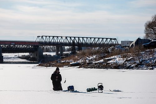 MIKAELA MACKENZIE / WINNIPEG FREE PRESS

Ethan Bartsch catches a small sauger while ice fishing on the Red River in Lockport on Friday, Dec. 3, 2021. He's already been fishing a half dozen times since the river froze about a week and a half ago. Standup.
Winnipeg Free Press 2021.