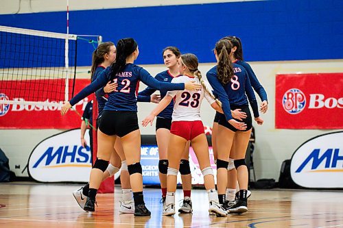 Daniel Crump / Winnipeg Free Press. The St. Mary&#x573; Flames celebrate a point during the AAAA Provincial High School Girl&#x573; Volleyball championships between against the JH Bruns Broncos at Sturgeon Heights Collegiate in Winnipeg, Saturday evening. December 4, 2021.