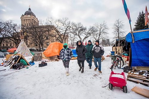 MIKAELA MACKENZIE / WINNIPEG FREE PRESS

Tyler Dodge (left), Aaliyah Leach, Willie Nicholas, and John Butler pose for a photo at the encampment on the legislative grounds in Winnipeg on Tuesday, Dec. 7, 2021. For Malak story.
Winnipeg Free Press 2021.