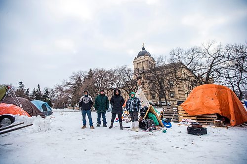 MIKAELA MACKENZIE / WINNIPEG FREE PRESS

John Butler (left), Willie Nicholas, Aaliyah Leach, and Tyler Dodge pose for a photo at the encampment on the legislative grounds in Winnipeg on Tuesday, Dec. 7, 2021. For Malak story.
Winnipeg Free Press 2021.