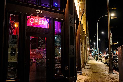 Mike Sudoma / Winnipeg Free Press
An &#x201c;Open&#x201d; sign hangs brightly above the front door of the Times Changed in downtown Winnipeg Tuesday night
December 7, 2021 