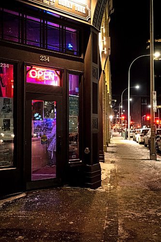 Mike Sudoma / Winnipeg Free Press
An &#x201c;Open&#x201d; sign hangs brightly above the front door of the Times Changed in downtown Winnipeg Tuesday night
December 7, 2021 