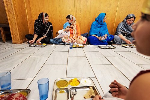 PRABHJOT SINGH / WINNIPEG FREE PRESS

Women can be seen talking to each other while sitting in a queue for food to be served.
In the community kitchen of Gurdwara Singh Sahab on Sturgeon Road in Winnipeg, a five-course meal is prepared by a host of Sikh devotees for the weekly Sunday langar.

