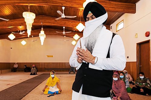 PRABHJOT SINGH / WINNIPEG FREE PRESS

Bikram Singh is seen praying with a sacred dagger in hands, which is then swiped through the food.
In the community kitchen of Gurdwara Singh Sahab on Sturgeon Road in Winnipeg, a five-course meal is prepared by a host of Sikh devotees for the weekly Sunday langar.

