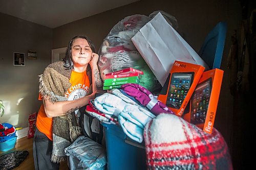 MIKAELA MACKENZIE / WINNIPEG FREE PRESS

Alaya McIvor poses for a portrait with Christmas donations for residential school survivors in Winnipeg on Thursday, Dec. 9, 2021. For Tyler story.
Winnipeg Free Press 2021.