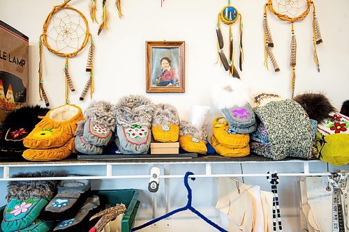 Mike Sudoma / Winnipeg Free Press
Handmade moccasins line a shelf in the Cree Ations shop with a baby photo of owner, Keith Proulx hung behind them
December 13, 2021 