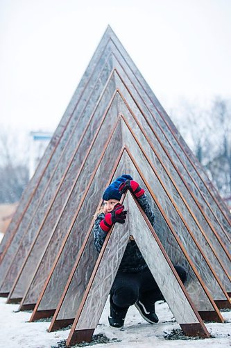 MIKAELA MACKENZIE / WINNIPEG FREE PRESS

James Isaac-Fehr (nine) plays at the formal opening of his mom's new new public art installation, The Eighth and Final Fire, at The Forks in Winnipeg on Wednesday, Dec. 15, 2021. For Al Small story.
Winnipeg Free Press 2021.