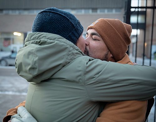JESSICA LEE / WINNIPEG FREE PRESS

Elijah Woodhouse (right), kisses girlfriend Irene Sanderson at Main Street Project on December 17, 2021 after walking 231 km to raise awareness about addiction and homelessness. He handed out snacks while walking and also gathered clothing and money donations for the Main Street Project. They are joined by family members and Main Street Project community members who celebrated the completion of his walk.













