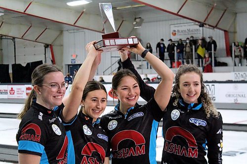 Lead Lauren Lenentine, left, second Emily Zacharias, third Karlee Burgess and skip Mackenzie Zacharias hoist up the Manitoba Scotties Tournament of Hearts trophy after a 7-5 victory over Kristy Watling in Sunday's final at the Carberry Plains Community Centre. (Lucas Punkari/The Brandon Sun)