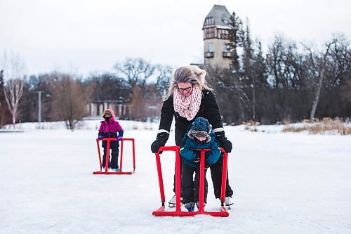 MIKAELA MACKENZIE / WINNIPEG FREE PRESS

Bennett Johnston, three, skates with his mom, mom, Laura Fletcher, for the very first time (on his brand new skates that he opened on Christmas morning) with his older sister, Olivia Johnston (four), behind at Assiniboine Park in Winnipeg on Saturday, Dec. 25, 2021.  Standup.
Winnipeg Free Press 2021.