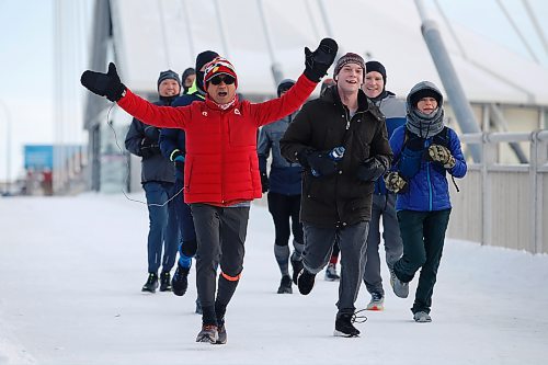 JOHN WOODS / WINNIPEG FREE PRESS
Junel Malapad, left, celebrates after completing his first lap of his 48hrs/200kms charity run in Winnipeg on Sunday, December 26, 2021. Malapad is raising money for Siloam Mission.

Re: Kitching