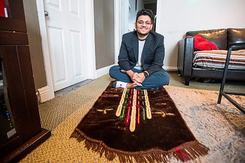 MIKAELA MACKENZIE / WINNIPEG FREE PRESS

Haseeb Ahmad poses for a portrait with a prayer mat, as he will be taking the new days off on Eid, in Winnipeg on Monday, Dec. 27, 2021.  For Bryce Hunt story.
Winnipeg Free Press 2021.