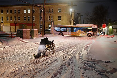 JOHN WOODS / WINNIPEG FREE PRESS
A man pushes his wheelchair as he makes his way down McGee St after a day of heavy snowfall in Monday, December 27, 2021. Twenty centimetres were expected to fall before the end of day.

Re: ?