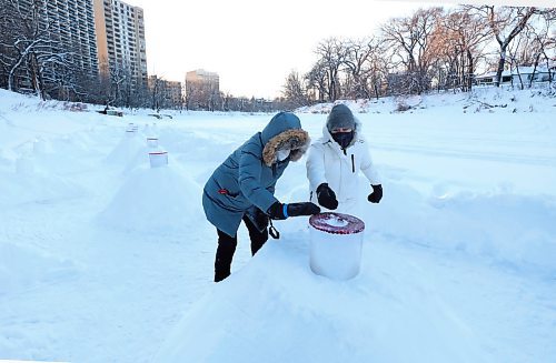 RUTH BONNEVILLE / WINNIPEG FREE PRESS

LOCAL - Helix path

Hazel Borys (white coat) and Sonia Lundstrom, who helped Sonia build the helix walking path,  brush off snow on one of the candle mounds along the path on the Assiniboine River Wednesday. 

Story  focuses on what goes into building the path and the ice lanterns they craft for light/decoration. 



Dec 29th,,  2021
