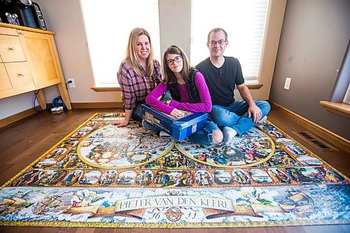 MIKAELA MACKENZIE / WINNIPEG FREE PRESS

Nicole (left), Alexa, and Marc Storozuk pose for a portrait with the completed 9,000 piece puzzle in their home in West St. Paul on Thursday, Dec. 30, 2021. For Bryce Hunt story.
Winnipeg Free Press 2021.