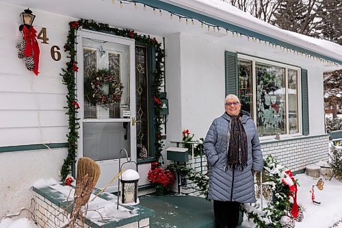 Genevieve Howard showcases her hand painted Christmas window art Thursday at her home. (Chelsea Kemp/The Brandon Sun)