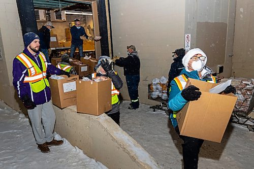 Vincent Massey High School volunteers load hampers for delivery at the Brandon and Westman Christmas Cheer headquarters on Wednesday, Dec. 15. (Chelsea Kemp/The Brandon Sun)