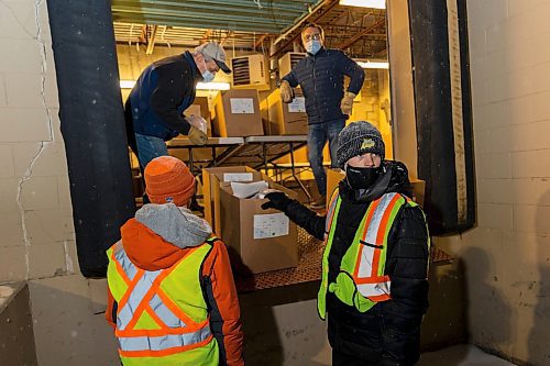 Vincent Massey High School volunteers load hampers for delivery at the Brandon and Westman Christmas Cheer headquarters on Wednesday, Dec. 15. (Chelsea Kemp/The Brandon Sun)