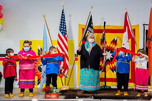 Elder Linda Eastman and community youth cut the ribbon marking the grand opening of the Canupawakpa Dakota Oyate community centre Wednesday. (Chelsea Kemp/The Brandon Sun)