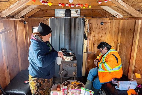 Liz, left, and Darcy Robins spend the day ice fishing at Lake Wahtopanah on Tuesday, Dec. 28. (Chelsea Kemp/The Brandon Sun)