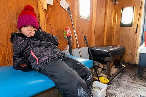 Jessica Robins, 7, sits in her families ice fishing shack at Lake Wahtopanah on Tuesday, Dec. 28. (Chelsea Kemp/The Brandon Sun)