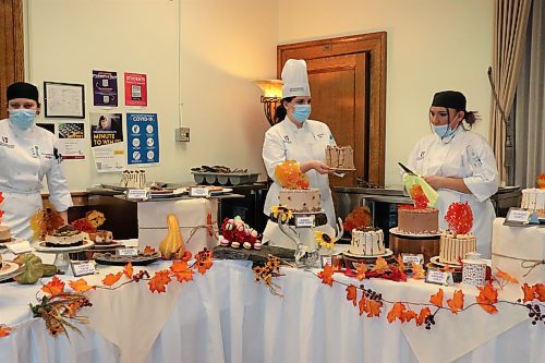 Kaitlin McCarthy, middle, and other members of the Assiniboine Community College culinary arts program bring out a variety of desserts during the school's Farewell to Fall event, which took place at the Manitoba Institute of Culinary Arts on Dec. 2. (Kyle Darbyson/The Brandon Sun)