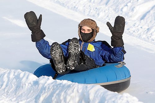 03012021
Rixon Suski throws up his arms while cruising down the tubing track at Tubin' at Grand Valley Park on a crisp Monday afternoon. (Tim Smith/The Brandon Sun)