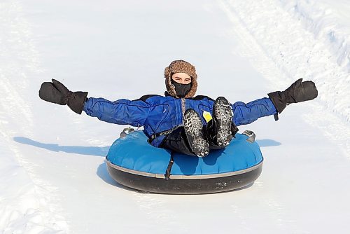 03012021
Rixon Suski throws up his arms while cruising down the tubing track at Tubin' at Grand Valley Park on a crisp Monday afternoon. (Tim Smith/The Brandon Sun)