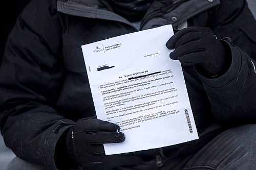 MIKAELA MACKENZIE / WINNIPEG FREE PRESS

Richard Kippen, a landlord who is so far on the hook for a tenantsՠunpaid water bill, poses for a portrait with a letter from the city in Winnipeg on Wednesday, Jan. 5, 2022. For Joyanne story.
Winnipeg Free Press 2022.