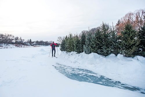 MIKAELA MACKENZIE / WINNIPEG FREE PRESS

Damian Konotopetz skis past the Christmas trees repurposed as a fire ring at the Wolseley Winter Wonderland on the Assiniboine River in Winnipeg on Wednesday, Jan. 5, 2022. For Malak story.
Winnipeg Free Press 2022.