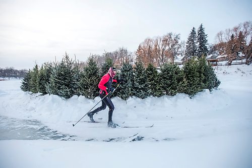 MIKAELA MACKENZIE / WINNIPEG FREE PRESS

Damian Konotopetz skis past the Christmas trees repurposed as a fire ring at the Wolseley Winter Wonderland on the Assiniboine River in Winnipeg on Wednesday, Jan. 5, 2022. For Malak story.
Winnipeg Free Press 2022.