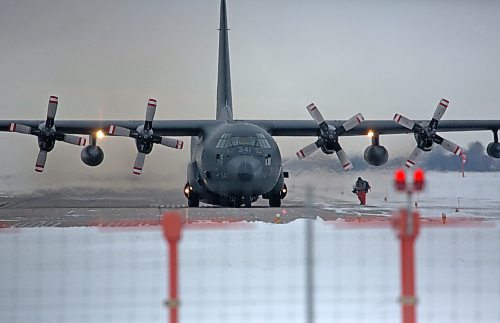 A ground crew member of 435 Transport and Rescue Squadron, based out of 17 Wing Winnipeg, approaches a C-130 Hercules aircraft after a morning of routine training north of Brandon at the Brandon Municipal Airport. (Matt Goerzen/The Brandon Sun)