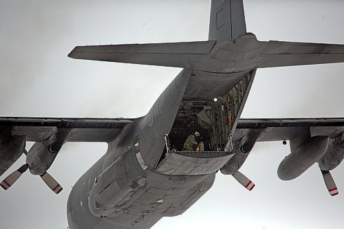 A soldier gets ready to drop a parachute with a payload out the rear cargo door of a C-130 Hercules aircraft as it flies over the Brandon Municipal Airport on Monday during a routine training session by members of 435 Transport and Rescue Squadron, which are based out of 17 Wing Winnipeg. (Matt Goerzen/The Brandon Sun)