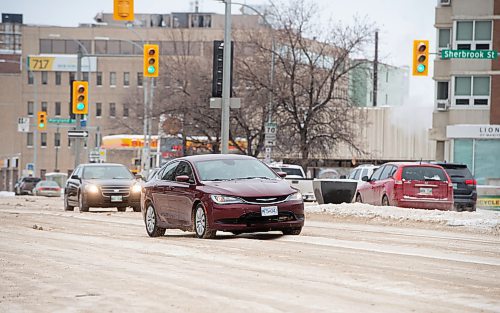 Mike Sudoma / Winnipeg Free Press
A car makes their way over the tall ruts of snow and ice as they switch lanes while going eastbound down Portage Ave Tuesday afternoon
January 11, 2022