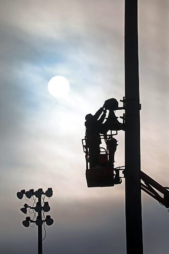 12012021
Corey Ellis with Industry Audio installs new speakers at Andrews Field as the sun shines through cloud cover on a mild Wednesday.  (Tim Smith/The Brandon Sun)