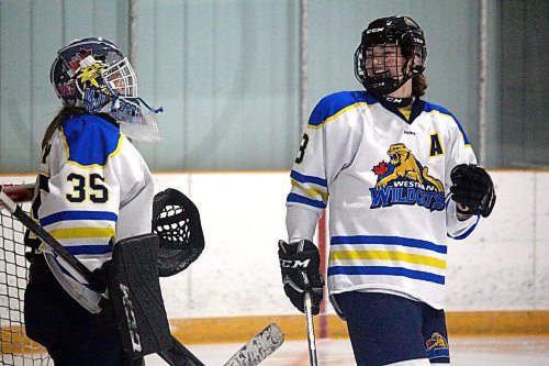 Westman Wildcats alternate captain Kelsey Page shares a laugh with goaltender Payton Murray during a game against the Yellowhead Chiefs in Hartney on Dec. 21, 2021. (Lucas Punkari/The Brandon Sun)