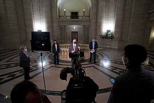 MIKE DEAL / WINNIPEG FREE PRESS
Wab Kinew (right), Leader of the Manitoba NDP, Malaya Marcelino (left), MLA for Notre Dame and Critic for Status of Women, and Adrien Sala (speaking), MLA for St. James, during a press conference in the Rotunda at the Manitoba Legislative building Friday morning.
See Carol Sanders story
220114 - Friday, January 14, 2022.