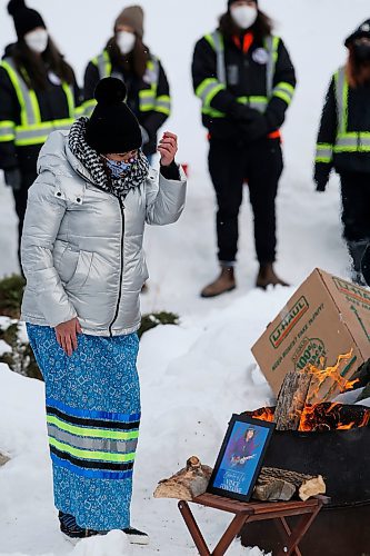 JOHN WOODS / WINNIPEG FREE PRESS
A woman puts tobacco in a fire at a memorial/celebration of life for musician Vince Fontaine at Oodena Circle at the Forks Sunday, January 16, 2022. 

Re: ?