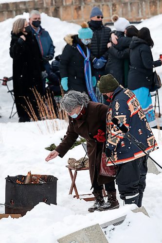 JOHN WOODS / WINNIPEG FREE PRESS
People place tobacco in a fire as they attend a memorial/celebration of life for musician Vince Fontaine at Oodena Circle at the Forks Sunday, January 16, 2022. 

Re: ?