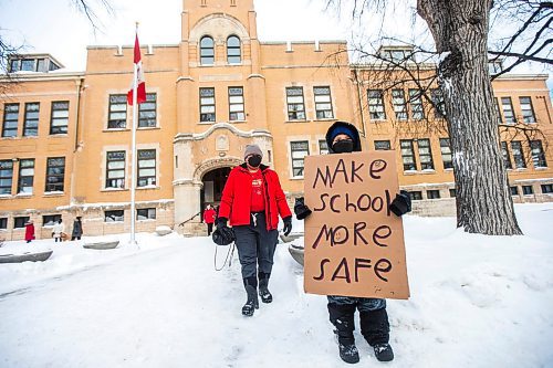 MIKAELA MACKENZIE / WINNIPEG FREE PRESS

Kenny Kennedy (nine) and his mom, Dawnis Kennedy, do a school walk-out at Isaac Brock School in Winnipeg on Monday, Jan. 17, 2022. Kenny is currently learning from home, as he doesn't feel safe in the classroom, and would like a school-based remote option (to continue his Ojibwe language program, stay connected to friends, and have the opportunity to go back to in-classroom learning later in the school year). For --- story.
Winnipeg Free Press 2022.