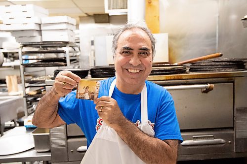 MIKE SUDOMA / Winnipeg Free Press
Gerry Lomonaco, owner of the Sorrentos location on Ellice Ave, holds up a picture of himself working in the same kitchen as he still works 36 years later.
September 24, 2021