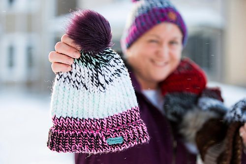 MIKAELA MACKENZIE / WINNIPEG FREE PRESS

Kyla Simms poses for a portrait with her toques in Winnipeg on Tuesday, Jan. 18, 2022. She is an armed forces veteran who has ptsd and, as therapy, was taught how to use a type of loom to make toques. She has since made so many she was able to give some to fellow patients and nurses at the health care facility in Ontario she was at and has recently donated 50 of them to Lighthouse Mission. For Kevin story.
Winnipeg Free Press 2022.